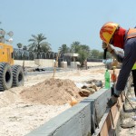 Foreign laborers work at the site of a new road in Doha, Qatar, last month. According to recent media reports, immigrants working on projects for the World Cup in 2022 have been subject to abuse and harsh working conditions.